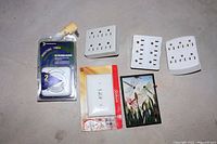 Lot of electrical items: three 6-outlet extenders, two face plates including one decorative butterfly and floral plate, and Intermatic timer.