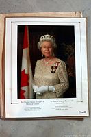 Full view of official portrait poster showing Queen Elizabeth II in formal attire with Canadian flag background