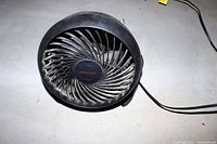Front view showing the spiral blade guard and Honeywell logo on the fan center.