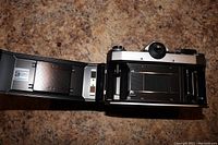 Open back view of Praktica Super TL camera showing film compartment and loading mechanism.