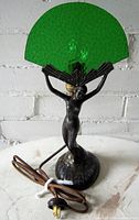 Front view of lamp showing full figurine base and green fan shade