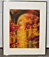Framed watercolor painting showing vibrant colors of autumn foliage in impressionist style, with a white mat and silver frame.