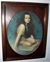 Full view of the framed Victorian winged fairy art print showing the girl seated with fairy wings in a dark wood frame.