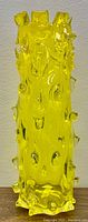 Full view of vibrant yellow stalactite Murano glass vase showing textured protrusions and uneven rim.
