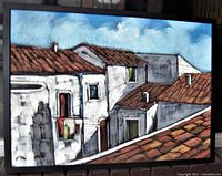 Front view of the textured sand painting of Italian rooftops in a dark wood frame.