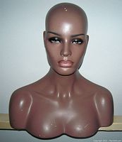 Front-facing photo of the mannequin bust showing detailed facial features, tanned skin tone, and slight surface wear.