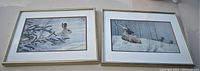 Pair of framed Robert Bateman art prints: Hare in Winter and Moose in Snow, showing overall condition and framing