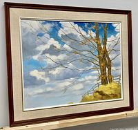 Painting at slight right angle in wood frame with linen mat, showing overall presentation