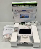 Curtis 7-inch under counter LCD TV clock radio with box, remote control, mounting screws, and power cord.