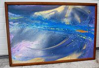 Framed abstract oil painting on canvas showing full artwork with vibrant and varied colors, and the artist signature visible.