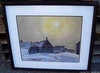 Front view of framed art print showing winter scenery under sun with dark wood frame and white mat with gold inner border.