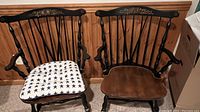 Pair of black Windsor-style armchairs side by side showing overall condition and finish