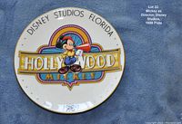 Full view of the Disney Studios Florida Hollywood Mickey collector's plate, 1989 edition, showing colorful Mickey Mouse design and gold rim on a blue fabric background.