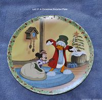 Full view of the circular plate showing Mickey Mouse and Scrooge McDuck in a Christmas scene indoors with decorated tree, clock, and sack, bordered by holly leaves and berries pattern.