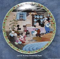 Front view of the collectible plate showing Mickey Mouse and Minnie Mouse in a Christmas scene with holly border