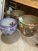 Photo showing all three large ceramic planters with detailed designs and varying sizes.