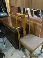 Photo showing Queen Anne style chair with upholstered seat in front of Red Seal cedar hope chest