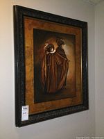 Full view of the framed painting showing two figures in period costume, dark and gold tones.