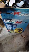Photo showing the original box of the Clean Jet 1400TSS pressure washer with branding and specifications.