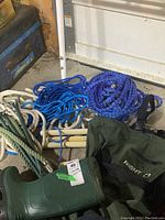 Photo showing green Night Cat chest waders size 7, several coils of blue and white nylon ropes, white plastic rungs of rope ladder