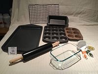 Overall view of all baking tools: cookie sheets, pans, rolling pin, cooling rack, measuring cups
