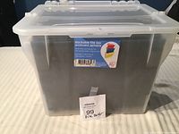 Front view of clear plastic stackable file box with label on front and hinged lid.
