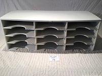 Full front view of a large white plastic 16-section file sorter with 4 horizontal levels and 4 compartments per level.