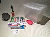 Full view of the lot including storage container, mirror, lint roller, toothbrushes, toothpaste, soap dish, and soaps.