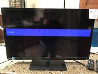 Front view of Toshiba 32 inch TV screen displaying 'NO VIDEO', with remote control placed to the right.