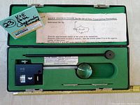 Complete view of K&E planimeter inside green felt-lined case with instructions and labeling.