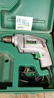 Skil Model 596-5 drill inside green molded plastic case showing whole drill and power cord.