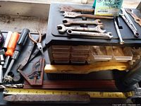 Overview of various hand tools including wrenches, try square, and storage drawers beneath