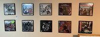 Two rows of five black wood framed vinyl album covers mounted on wall
