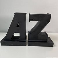 Pair of black matte letter bookends shaped as A and Z with white background.