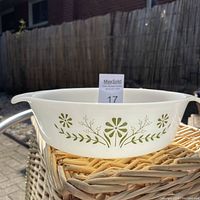 Side view of Glasbake milkglass casserole showing green floral pattern and integrated handles.