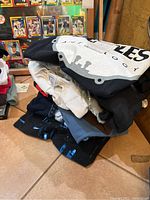 Stack of folded Beatles T-shirts in assorted colors, showing multiple designs and tags.