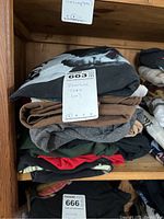 Stack of folded T-shirts with label indicating 10 Beatles tees