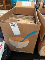 Cardboard box labeled Splendid filled with stacked vinyl LPs