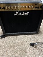 Front view of Marshall MG30DFX amplifier showing control panel with various knobs and input jack, and Marshall logo on black mesh grille.
