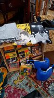 Overall lot containing Muhammad Ali collector t-shirts, Everlast boxing gloves, boxed Ring Classics reel-to-reel tapes, and assorted boxing magazines.
