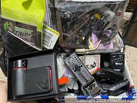 Bags of guitar accessories including capos, tuners, Monster Grips, clip-on tuners, other small music equipment