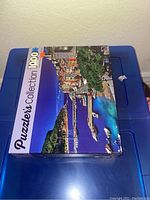 Puzzle box on a blue plastic storage container