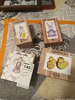 Four original boxed crystal figurines displayed on fabric surface: a crystal rabbit, a party bunny, a crystal angel, and a set of three crystal ducks. Labels and price tags visible on boxes.