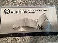 Closed retail box showing OMI PADS logo and product illustration