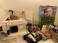 Full lot view with Singer sewing machine, craft supplies, organizers, and boxed tracing projector