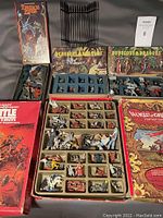 Overall assortment showing three open D&D boxed sets, red supplement box and World of Greyhawk cover