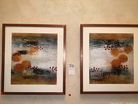 Two framed abstract wall art pieces hanging on a beige wall, showing overall appearance and style.