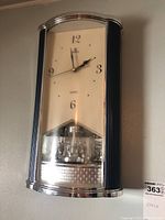 Front view of the vintage Power Quartz wall clock showing the clock face and decorative pendulum section.