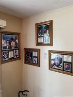 Four framed music posters displayed on two walls, featuring Jimi Hendrix, The Beatles, and The Rolling Stones in gold-tone frames.