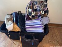 Tote of various ladies purses including patchwork leather, striped, and solid colored handbags